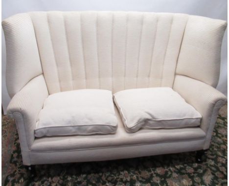 Edwardian upholstered sofa with pleated high wing back, outscrolled arms and two loose seat cushions on cabriole legs with pa