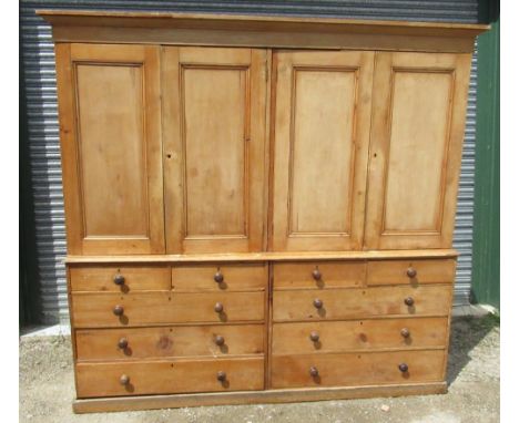 Large Victorian waxed pine housekeepers cupboard, moulded cornice above four panel doors with fitted shelves, projecting base