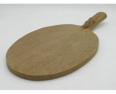 Robert Mouseman Thompson of Kilburn - an adzed oak oval cheese board, curved handle carved with signature mouse, L40cm W20cm 