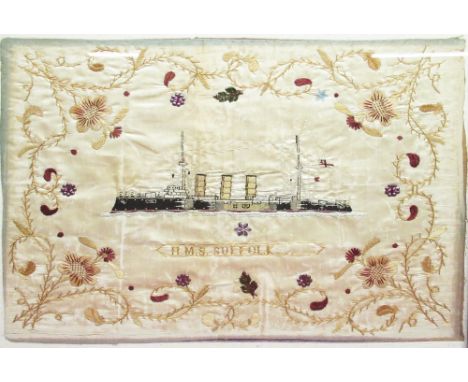 Early C20th silkwork ships portrait of HMS Suffolk at steam, titled and worked in colours in scrolling floral and metal borde