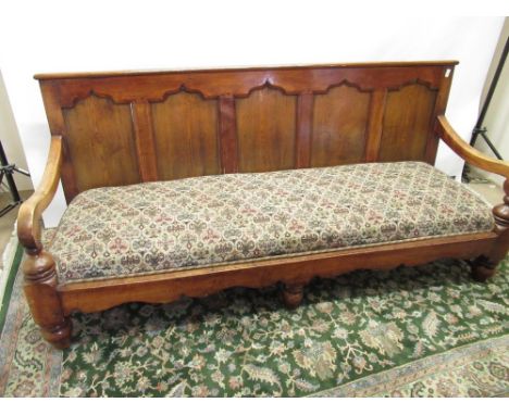 Early C20th country made oak and other wood bench seat, five panel back with upholstered seat on turned supports joined by st