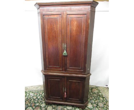 Geo.III mahogany standing corner cupboard, moulded cornice above four ovolo panel doors with four shelves, on bracket feet, W