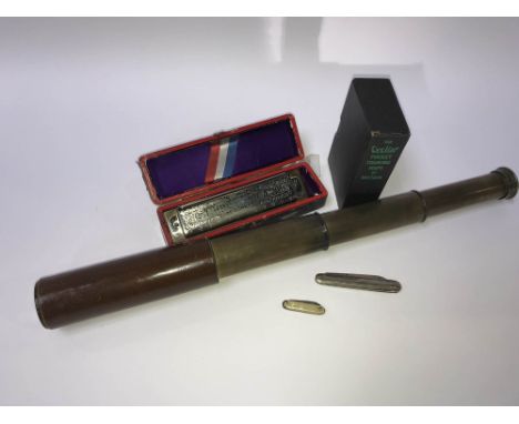 A pocket telescope, a Hohner Super Chromonica, a silver pen knife etc