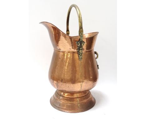 COPPER HELMET SHAPED COAL SCUTTLE
with a brass swing handle, 49cm high   