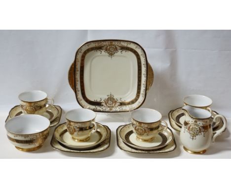 JAPANESE MEITO CHINA TEA SERVICE
with floral gilt scrolls on a black band, comprising five cups and saucers, seven shaped sid