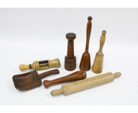 Collection of treen kitchenalia to include a bottle corker, potato masher, oat rolling pin and an unusual scoop with drainage