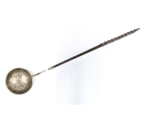 19th century white metal toddy ladle, the bowl with swirling pattern, with twisted baleen handle, 35cm long 