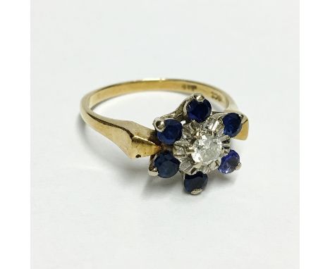 A sapphire and diamond snowflake shaped cluster ring in 18ct gold with 6 sapphires and 1 diamond, with insurance valuation ce