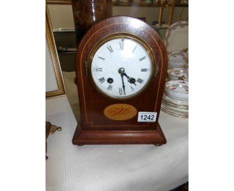 A mahogany inlaid mantel clock
