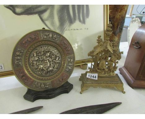An oriental brass plaque and one other item