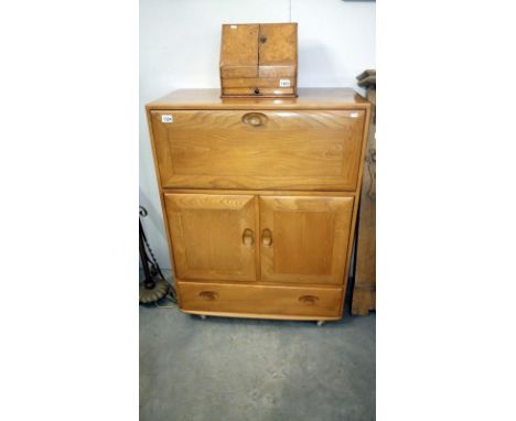 An Ercol 2 drawer, 2 door cabinet with fall flap