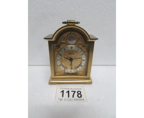 A Swiza Tempus Fugit brass carriage clock