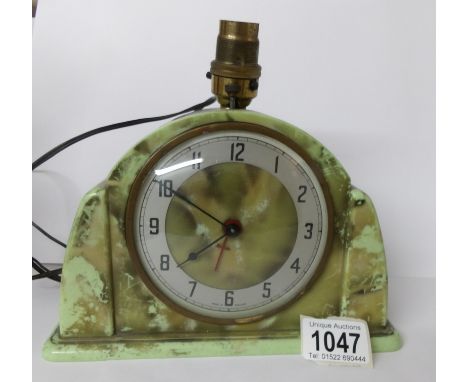 An Art Deco green bakelite Metamec electric clock/lamp