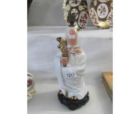 An Edwardian figure of an oriental gentleman as a table lamp