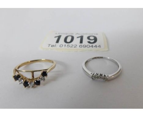 A white gold ring set white stones and a yellow gold ring set garnets