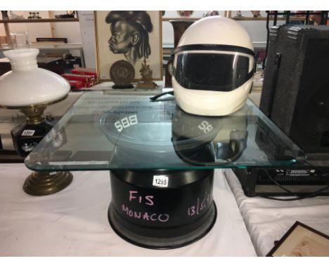 A BBS F9074 alloy racing car wheel marked F1S Monaco 13/5/99 with glass insert & used as a coffee table and a helmet