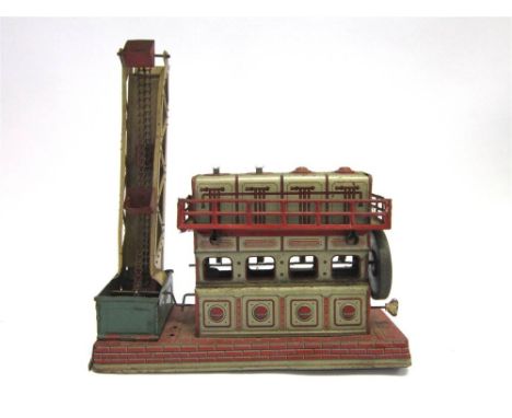 A GERMAN OROBR TINPLATE STATIONARY ENGINE AND EXCAVATOR with printed detail, fitted with a clockwork mechanism, generally goo