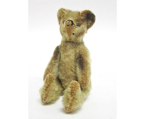 AN EARLY MINIATURE STEIFF PALE GOLD MOHAIR TEDDY BEAR circa 1910, with boot button eyes and the remains of a horizontally sti