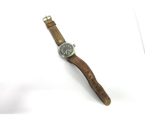A SECOND WORLD WAR BRITISH SERVICE ISSUE WRISTWATCH the circular black face with white Arabic numerals, the back engraved wit