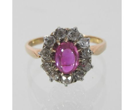 An 18 carat gold and ruby and diamond cluster ring