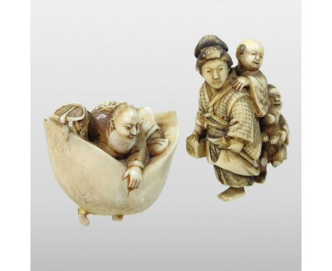 A 19th century Japanese carved ivory netsuke, of a man seated in a giant peach, signed, 3.5cm high, together with a netsuke o