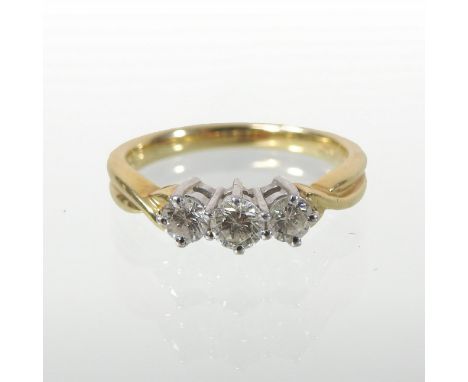 An 18 carat gold and diamond set three stone ring, stamped 760, boxed