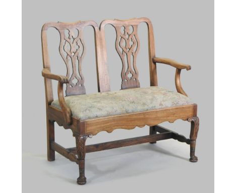 An Edwardian carved walnut chair back settee, of Chippendale design, with a tapestry seat, on cabriole legs, 106cm