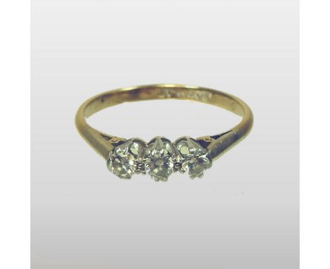 An 18 carat gold platinum set three stone diamond ring, with a single row of stones