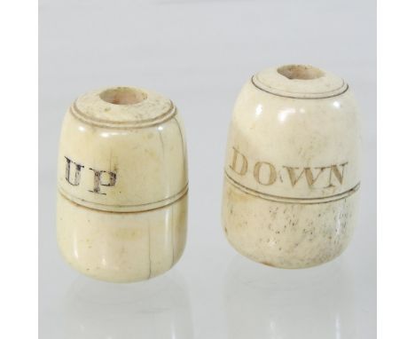 A pair of 19th century turned bone bell pulls, each of bobbin shape, inscribed UP and DOWN, 5cm high