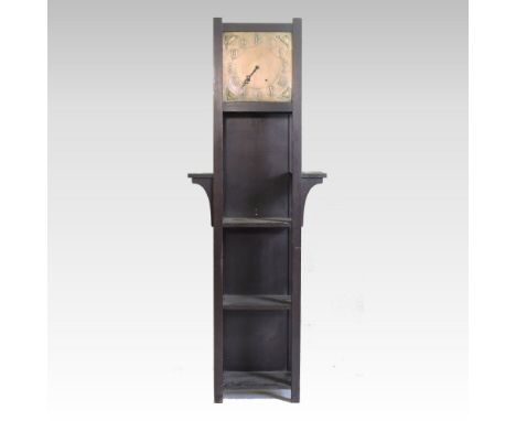 An Arts and Crafts style oak clock/bookcase, having a brass dial, with open shelves, the brass dial with a twin train movemen