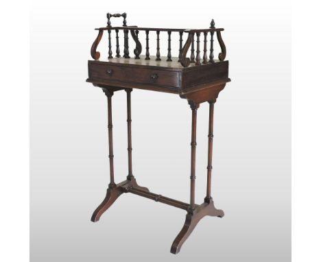A 19th century rosewood book trough, of small proportions, with a spindle gallery, on ring turned legs, 38cm 