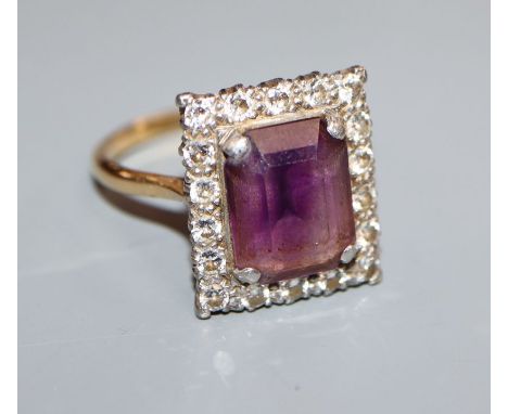 An 18ct and plat, amethyst and diamond set square cluster ring, size U.