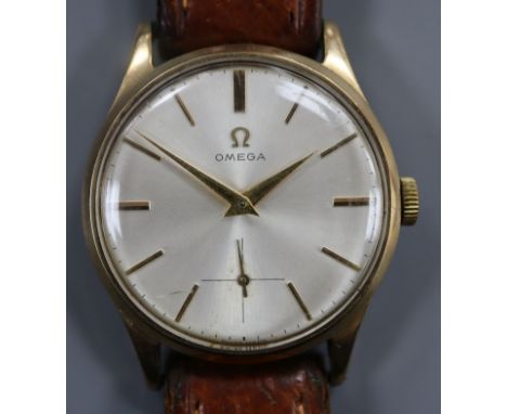 A gentleman's 1950's 9ct gold Omega manual wind wrist watch, on leather strap with Omega buckle, movement c.266.