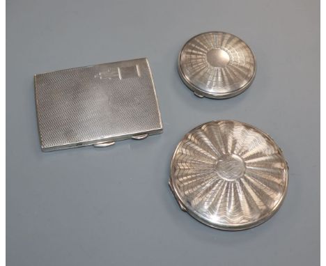 A silver cigarette case and two compacts.
