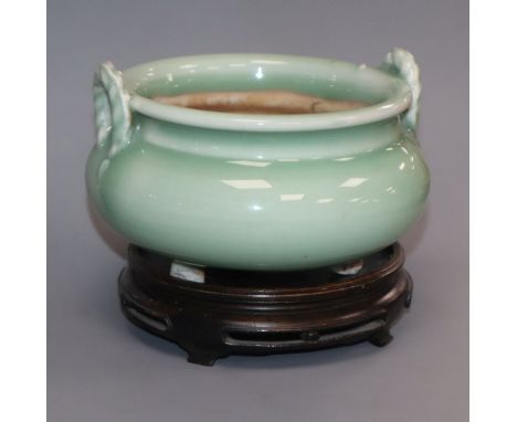 A Japanese celadon glazed tripod censer, wood stand Provenance - The owner and her family lived in Singapore in the late 1950