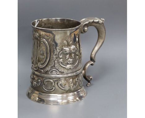 A late George II silver mug, with later embossed decoration, London, 1757 (a.f.), 12.9cm, 14.5 oz.