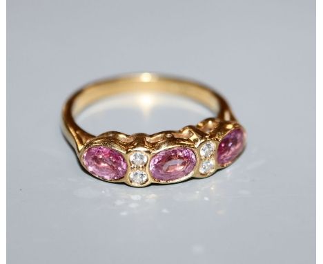 An 18ct gold, pink sapphire and diamond half-hoop ring, size M.