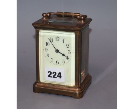 A brass carriage timepiece with enamel dial
