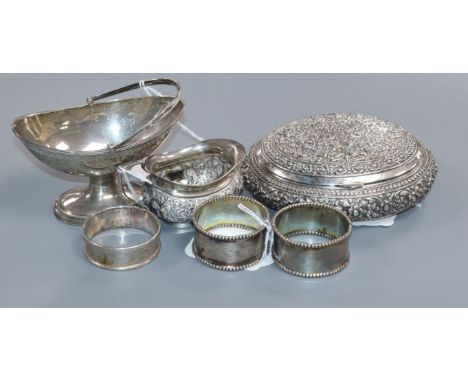 An Indian white metal embossed oval box, a Victorian silver salt and four other items.