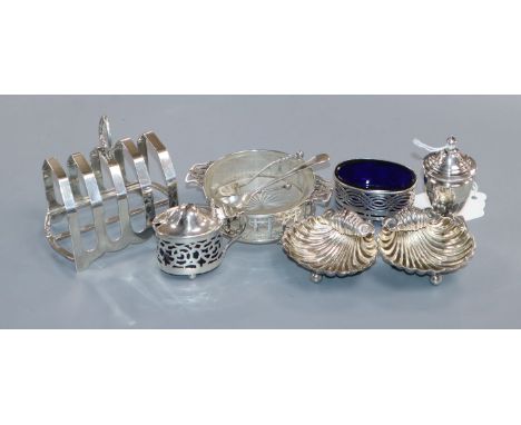 A pair of silver shell salts, a pepper pot and silver salt with glass liner and a matching pair of condiments &amp; silver to