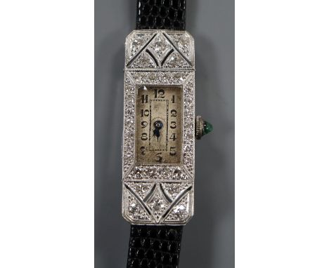 A lady's late 1920's 18ct white gold and diamond set rectangular cocktail watch, with cabochon emerald set winding crown.