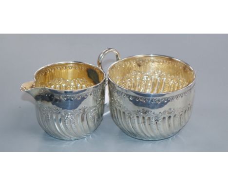 A late Victorian silver wrythen fluted cream jug and sugar bowl, Sheffield, 1890, 112 grams.