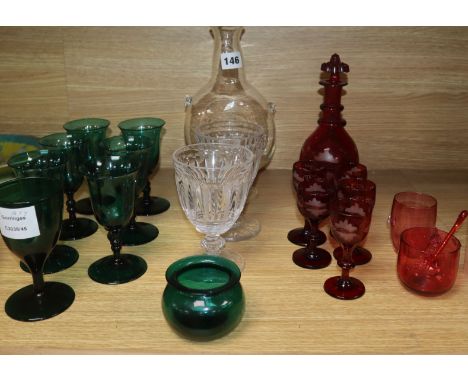 A set of six dark green wine glasses, a vine etched ruby glass decanter and five matching liqueur glasses, etc.