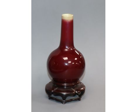 A small Chinese Langyao sang de boeuf bottle vase, 18th century, restored rim, wood stand Provenance - The owner and her fami