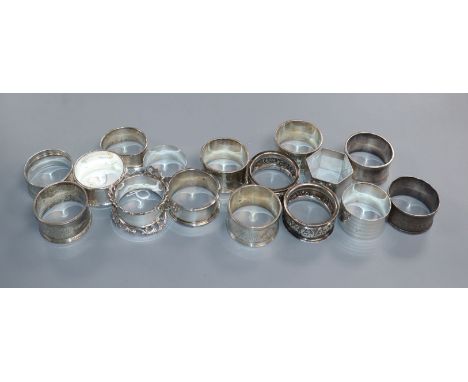 A set of five Edwardian silver serviette rings, one other pair and nine others, 13 oz.