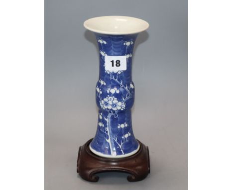 A Chinese blue and white 'prunus' beaker vase, 19th century, wood stand height 20cm excluding stand Provenance - The owner an