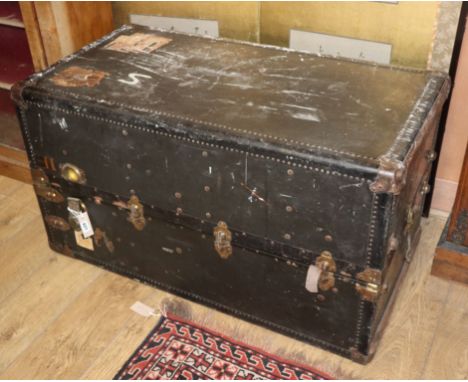 A 1920's leather and canvas covered travelling trunk / wardrobe W.105cm