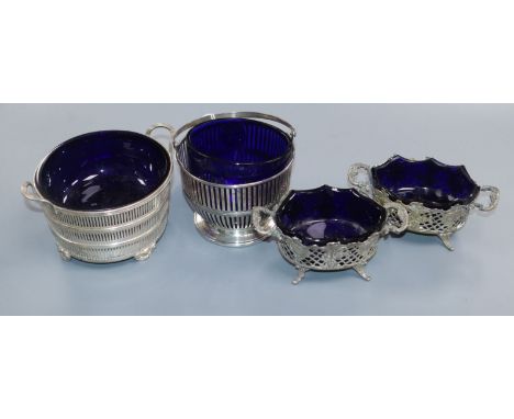 A 1930's pierced silver two handled dish with liner, a silver basket with associated liner and a pair of 800 white metal salt