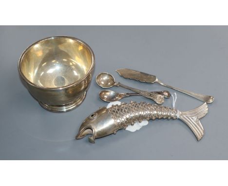 A Mexican white metal reticulated fish, a silver sugar bowl, two silver condiment spoons and a silver butter knife.