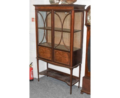 A Denby &amp; Spinks, Leeds, Mahogany Display Cabinet, the tapering square section supports joined by a shelf stretcher, circ